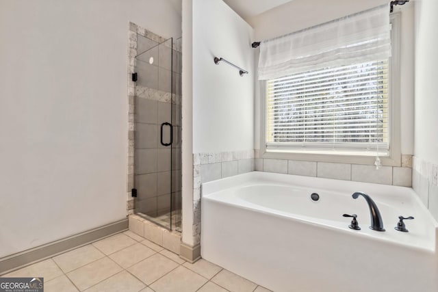 full bathroom featuring tile patterned floors, a garden tub, and a shower stall