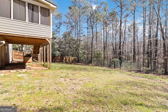 view of yard featuring stairway, a fenced backyard, and a sunroom