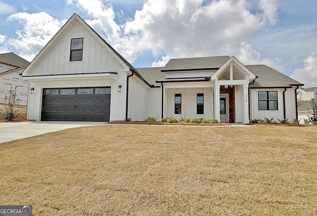 modern farmhouse style home featuring a front lawn, board and batten siding, concrete driveway, and roof with shingles