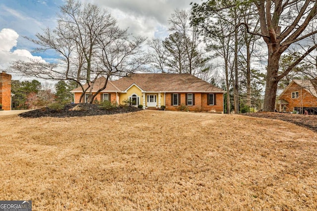 ranch-style home with a front lawn