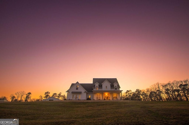 cape cod home with a front yard