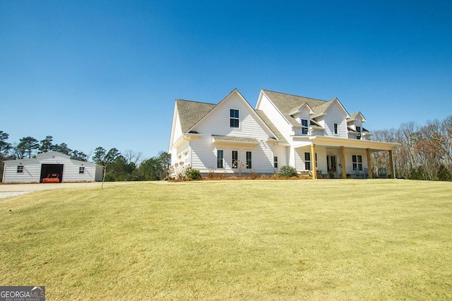 view of front of home featuring an outbuilding and a front yard