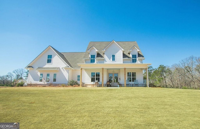 view of front of house with a front yard and french doors