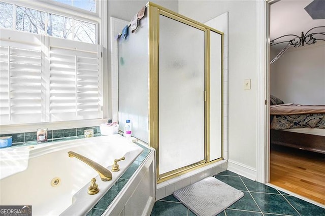 ensuite bathroom with a shower stall, ensuite bath, a tub with jets, and tile patterned floors