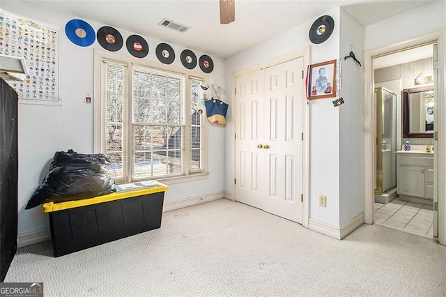 interior space featuring a closet, visible vents, and baseboards