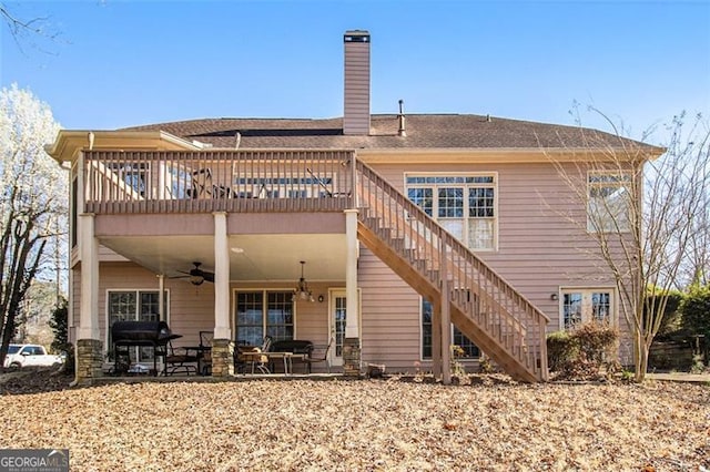 rear view of house with a patio, stairway, a chimney, and ceiling fan