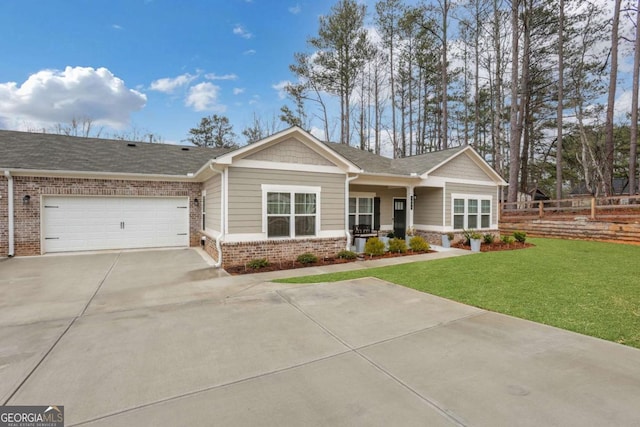 view of front of home with brick siding, a front lawn, fence, concrete driveway, and a garage