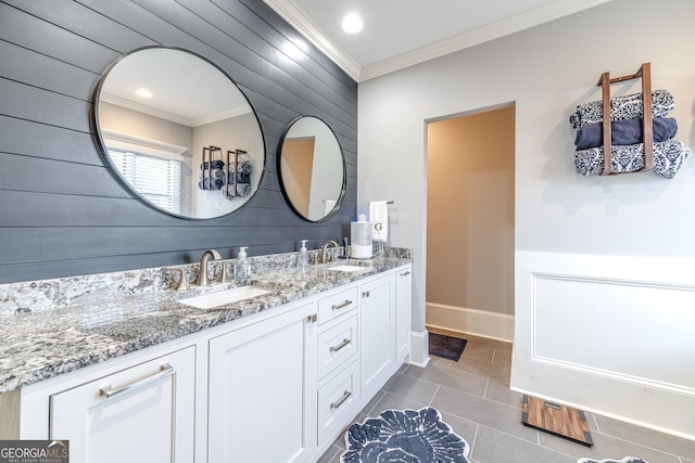 bathroom with double vanity, ornamental molding, tile patterned floors, and a sink