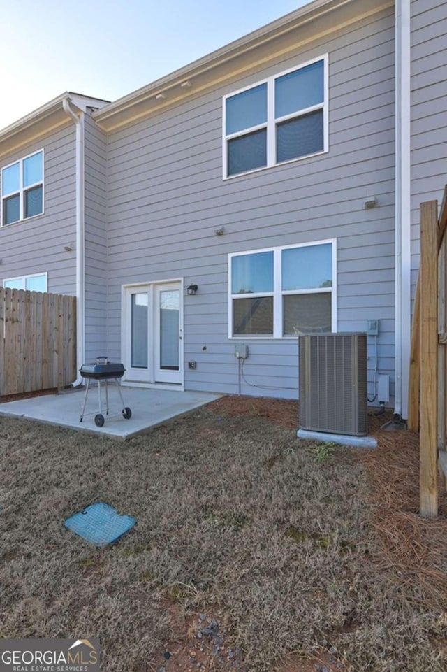 back of property with a patio, central AC, and fence