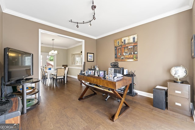 office space featuring baseboards, a notable chandelier, wood finished floors, and crown molding