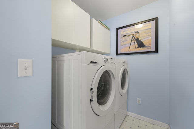 laundry area with baseboards, cabinet space, separate washer and dryer, and light floors