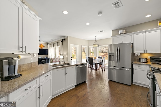 kitchen with white cabinetry, stainless steel appliances, and a sink