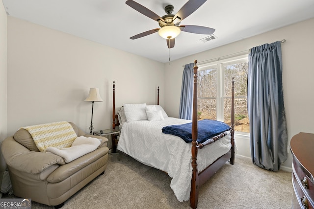 carpeted bedroom featuring visible vents, baseboards, and ceiling fan