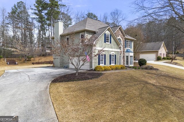 traditional home featuring stone siding, concrete driveway, an attached garage, a shingled roof, and a chimney