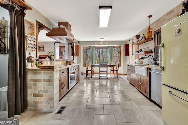 kitchen with visible vents, open shelves, stone tile flooring, stainless steel appliances, and light countertops