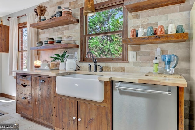 kitchen featuring open shelves, backsplash, stainless steel dishwasher, and light countertops