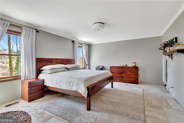 bedroom featuring stone tile floors, visible vents, and ornamental molding