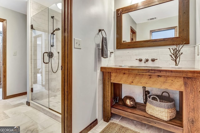 bathroom featuring visible vents, a stall shower, and vanity