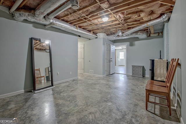 basement featuring baseboards and visible vents