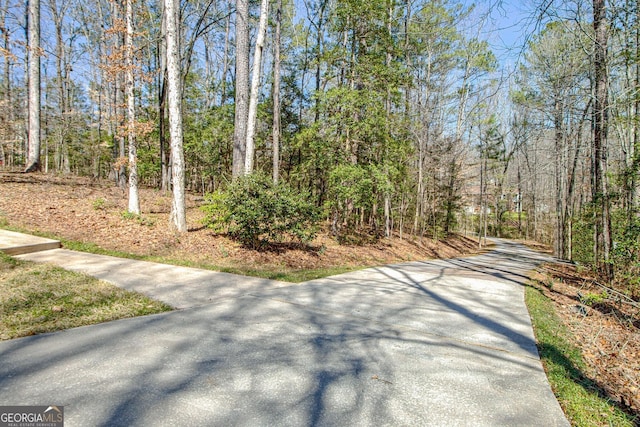 view of road featuring a wooded view