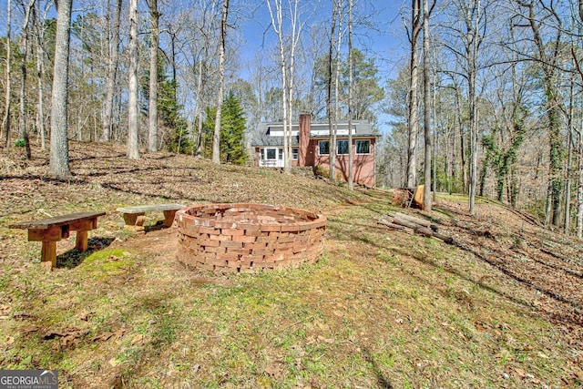 view of yard with a fire pit