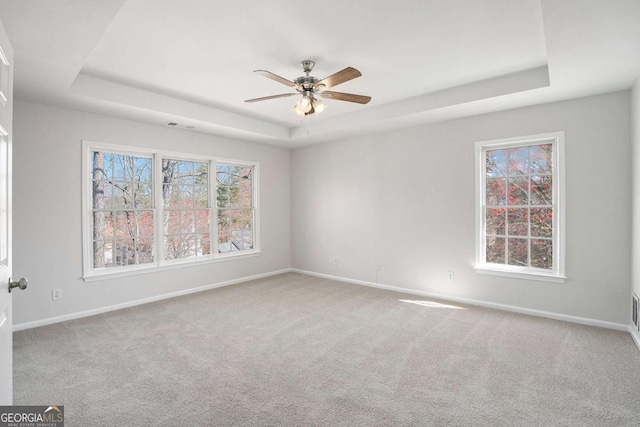 10950 Glenhurst Pass, Duluth, GA 30097 - unfurnished room featuring a tray ceiling, baseboards, a ceiling fan, and carpet