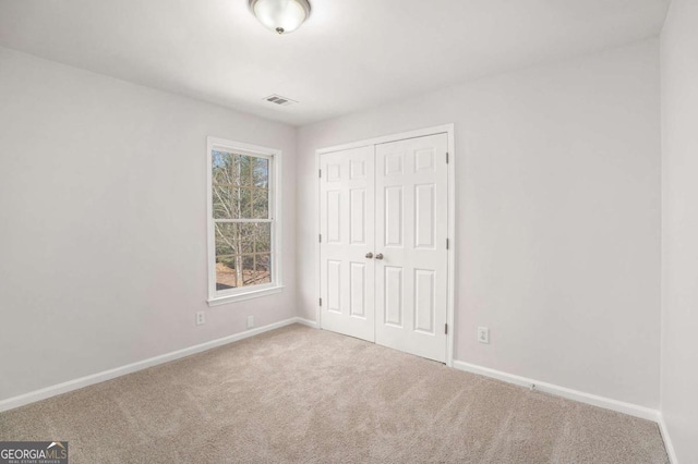 10950 Glenhurst Pass, Duluth, GA 30097 - unfurnished bedroom featuring carpet, baseboards, and a closet