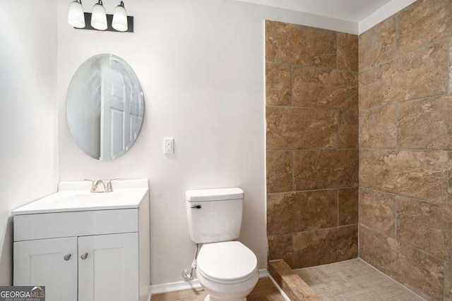 10950 Glenhurst Pass, Duluth, GA 30097 - full bathroom with toilet, vanity, a tile shower, and baseboards