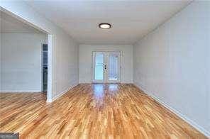 empty room featuring french doors and wood finished floors