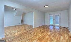 interior space featuring french doors, wood finished floors, and stairs