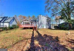 rear view of house with a wooden deck