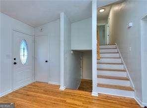 foyer with stairs and wood finished floors