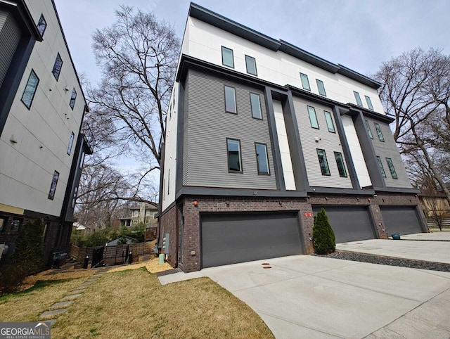 multi unit property featuring brick siding, an attached garage, and concrete driveway