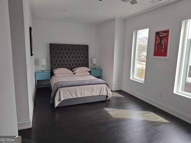 bedroom featuring baseboards and dark wood-style floors