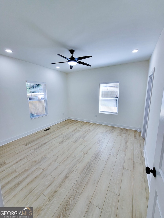 empty room with visible vents, baseboards, recessed lighting, ceiling fan, and light wood-type flooring