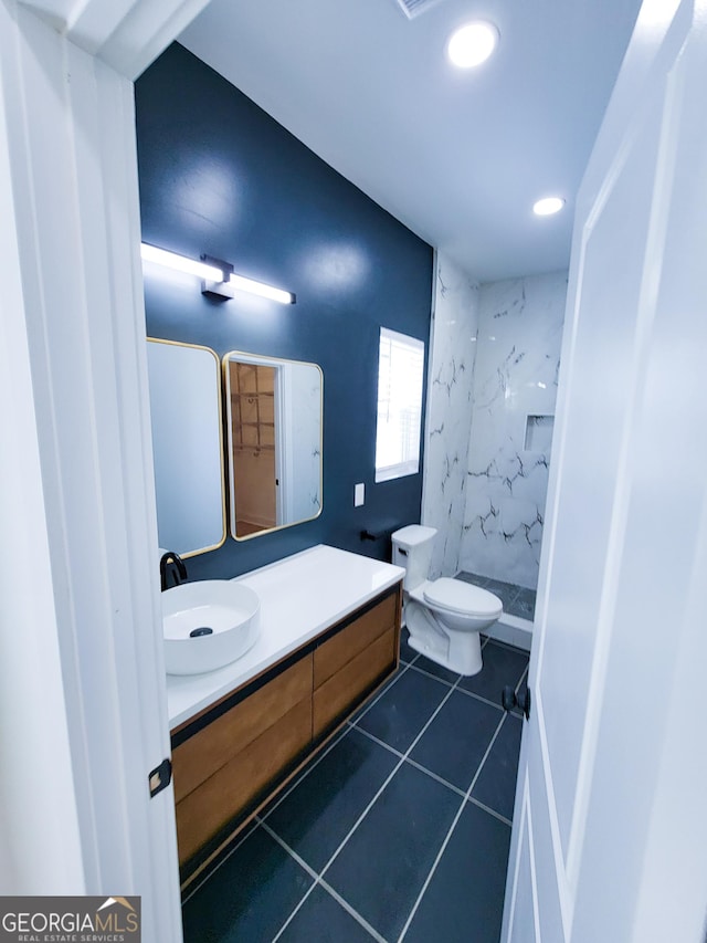 bathroom featuring vanity, recessed lighting, a stall shower, tile patterned flooring, and toilet