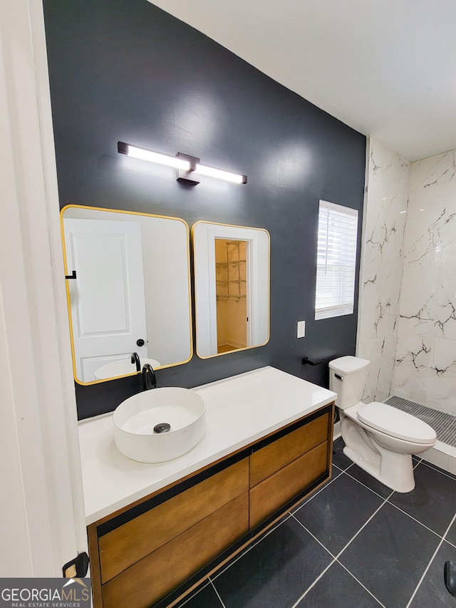 bathroom with vanity, toilet, a stall shower, and tile patterned flooring