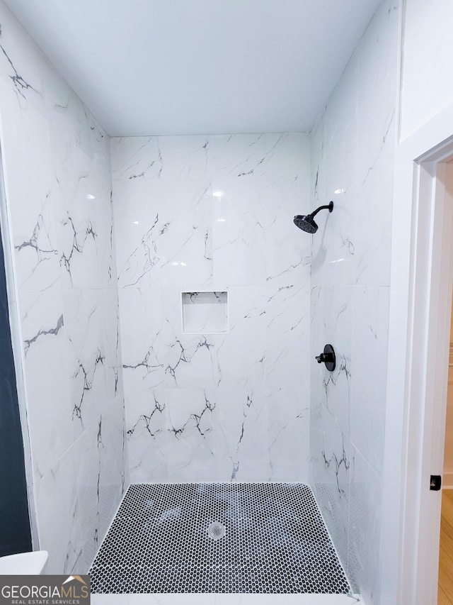 full bath featuring tiled shower