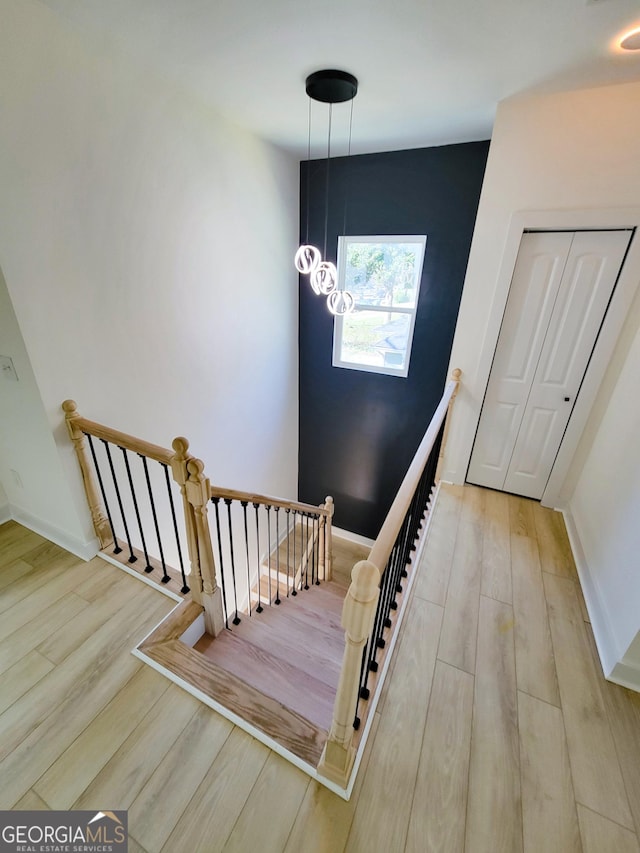 stairway featuring baseboards and wood finished floors