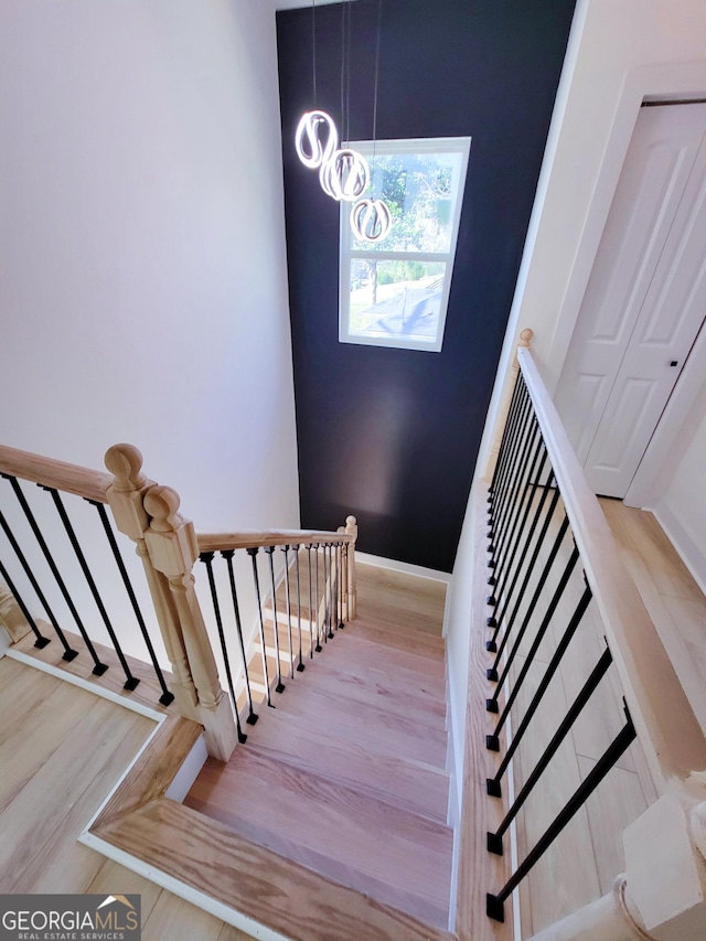 stairs with baseboards and wood finished floors