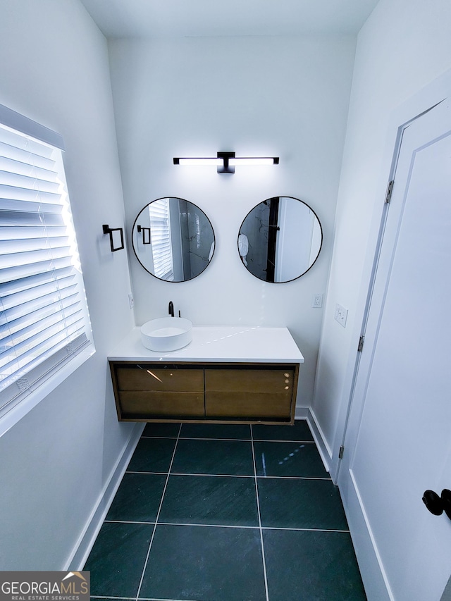 bathroom with tile patterned floors, vanity, and baseboards