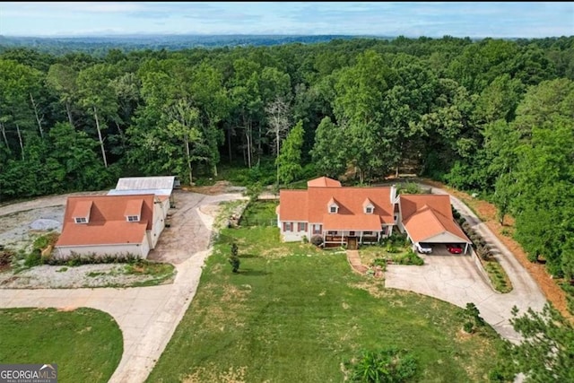 birds eye view of property with a forest view