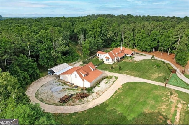 bird's eye view with a wooded view