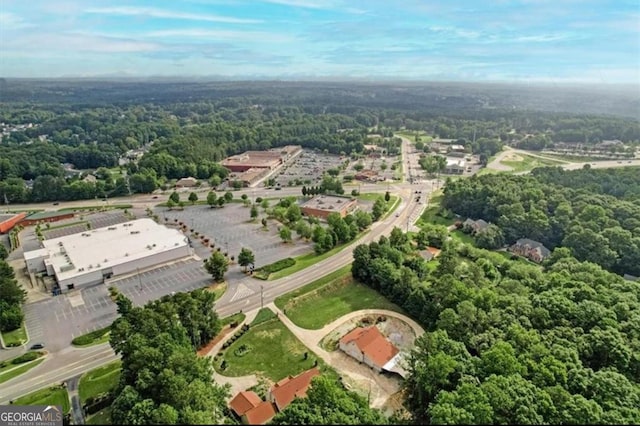 drone / aerial view featuring a wooded view