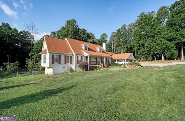 view of front of home with a front yard and fence