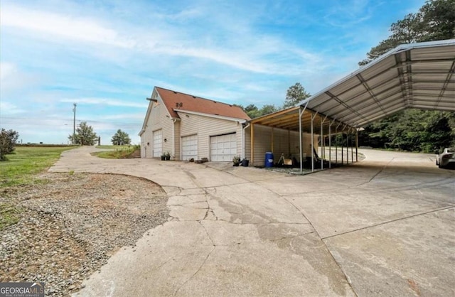 view of side of property with a carport and an outbuilding