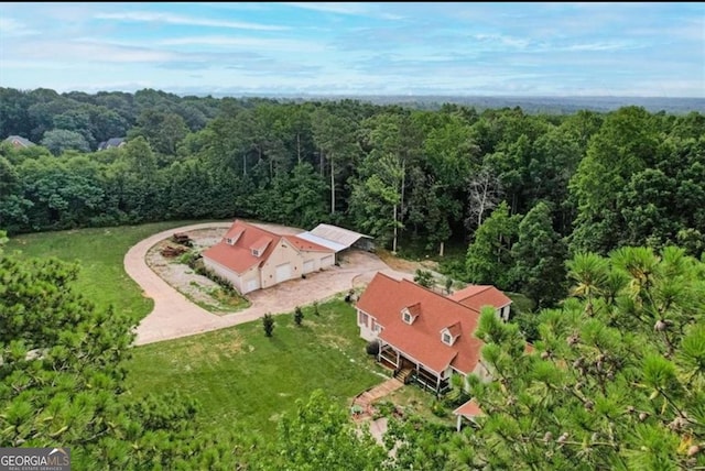 drone / aerial view featuring a forest view