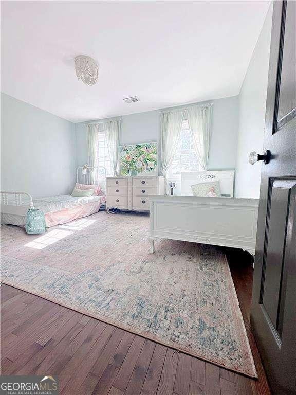 bedroom with wood finished floors and visible vents