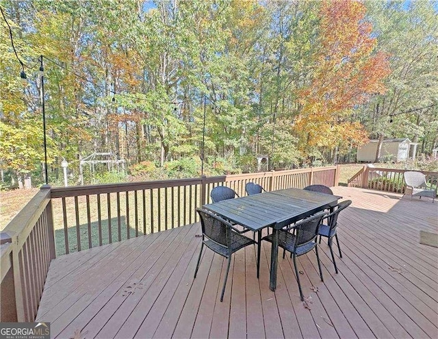 wooden deck featuring outdoor dining space