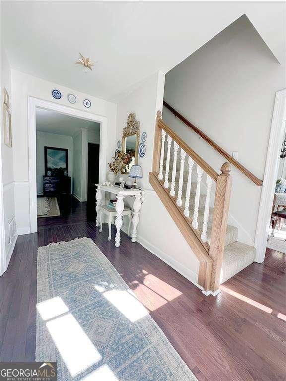 interior space with baseboards and wood finished floors